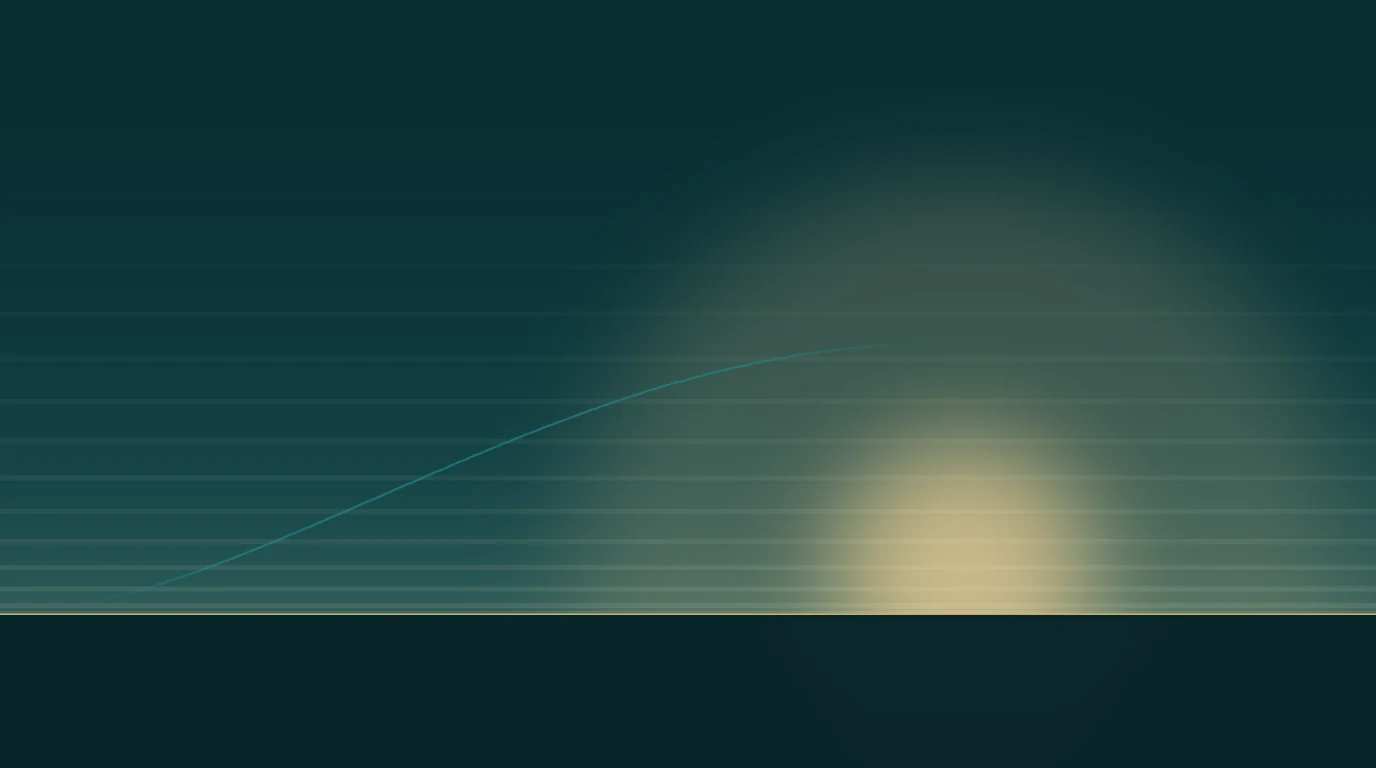 A low sunrise over a flat horizon, with a single pale curve rising toward it